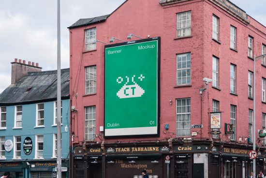 Outdoor billboard mockup on a red building featuring a green banner, ideal for designers to display advertising graphics in a realistic urban setting.